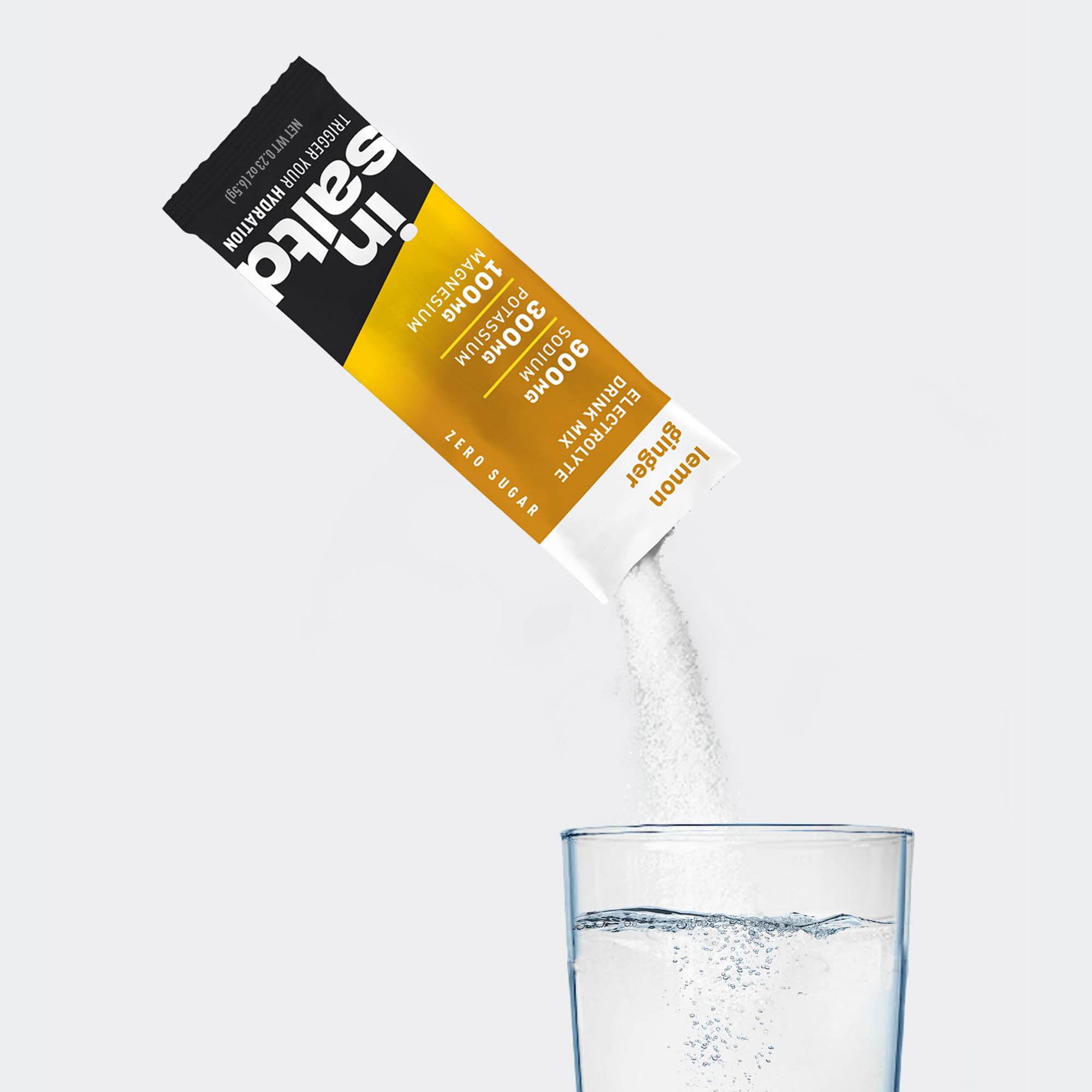 Insaltd Lemon Ginger hydration drink mix pouring into glass of water.