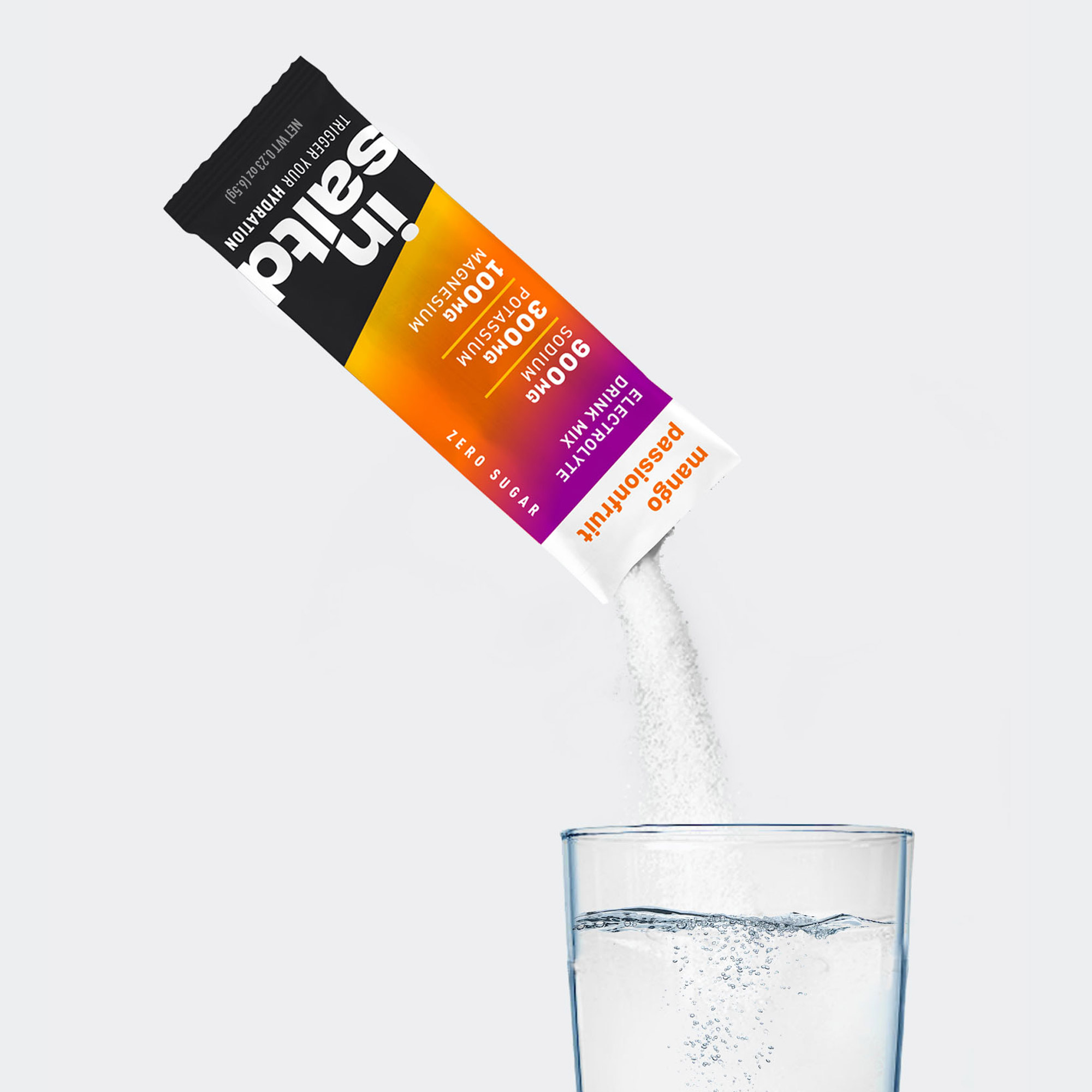Insaltd Mango Passionfruit hydration drink mix pouring into glass of water.
